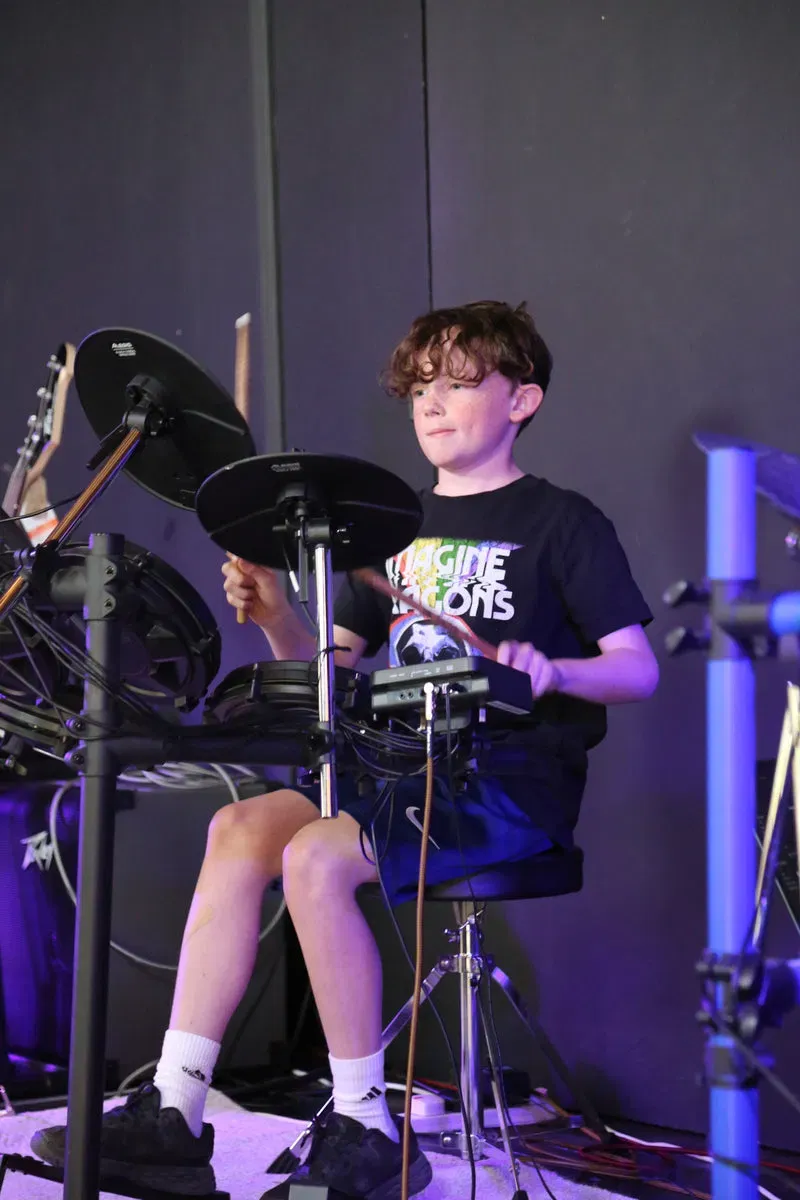 DeRosa pupil playing drums in a lesson