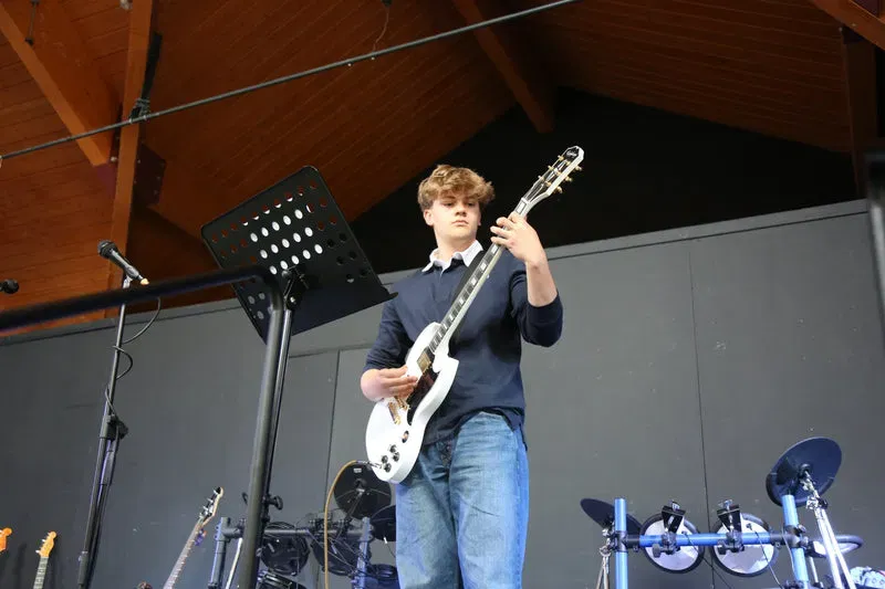 DeRosa pupil performing guitar on stage